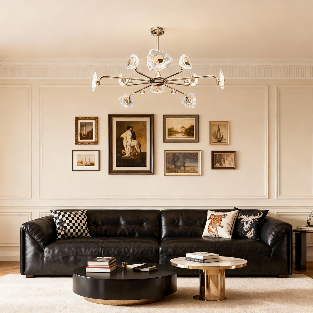 Crystal vintage chandelier providing ambient lighting in elegant living space with black leather sofa and gallery wall