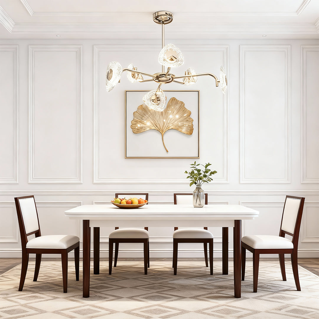 Crystal vintage chandelier illuminating formal dining room with white paneling and traditional furniture arrangement