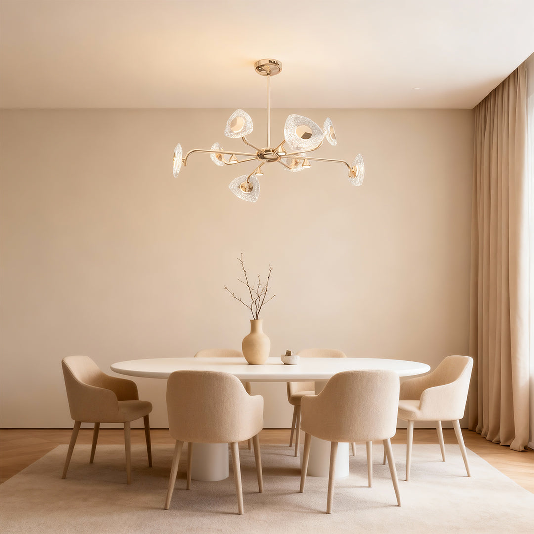 Crystal vintage chandelier illuminating minimalist dining area with neutral color palette and modern round table