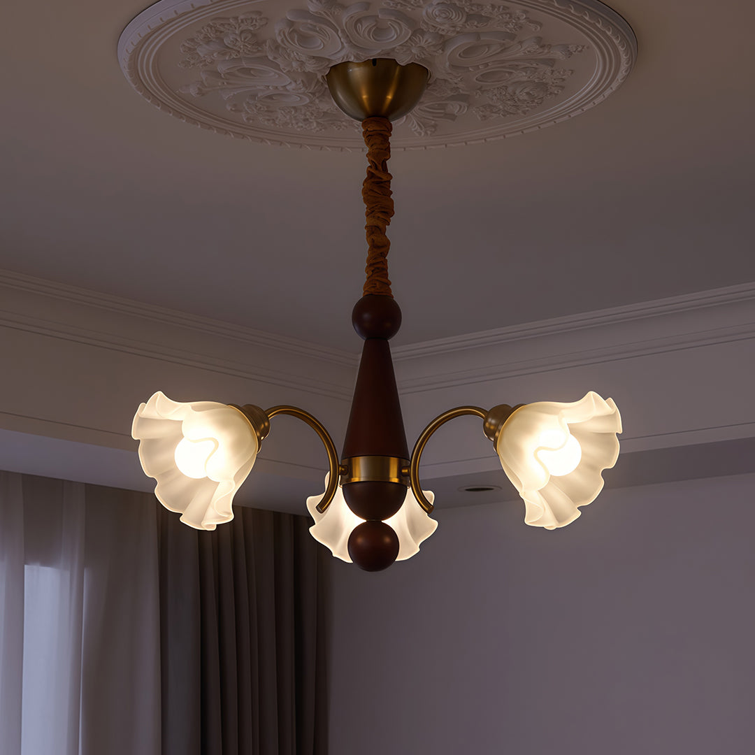 Crystal vintage chandelier with white flower shades illuminating traditional living room with beige sofa and neutral decor.