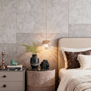 Soft ambient bedroom lighting with brass-and-crystal wall sconce lighting above the nightstand.