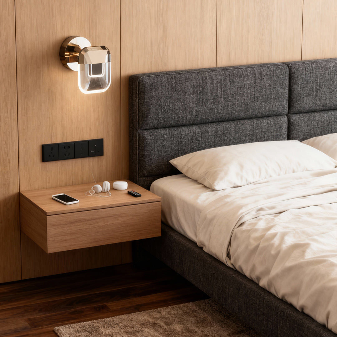 Crystal wall sconce lighting mounted above wooden nightstand in modern bedroom with upholstered headboard creating warm ambiance