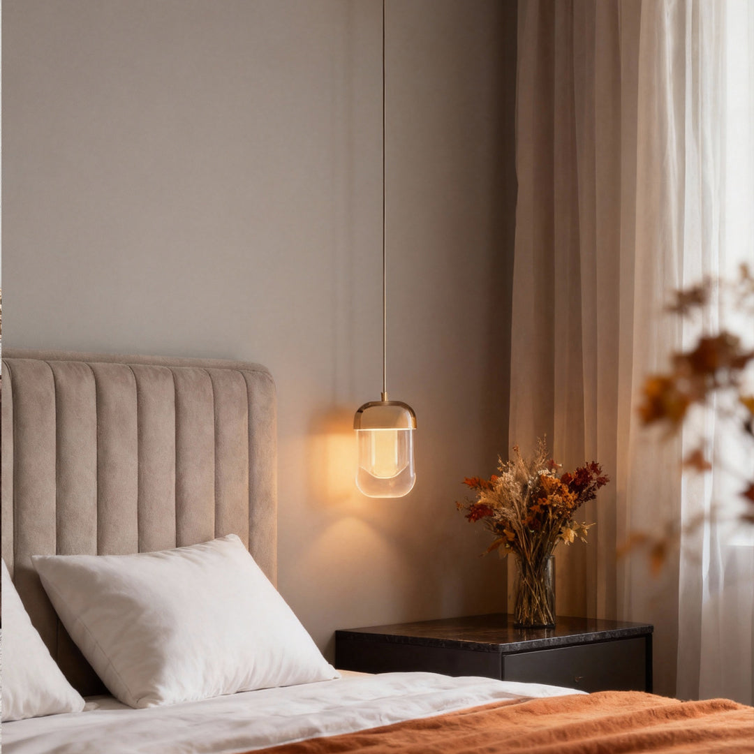 Warm-toned bedroom featuring hanging crystal wall sconce lighting next to a soft fabric headboard.