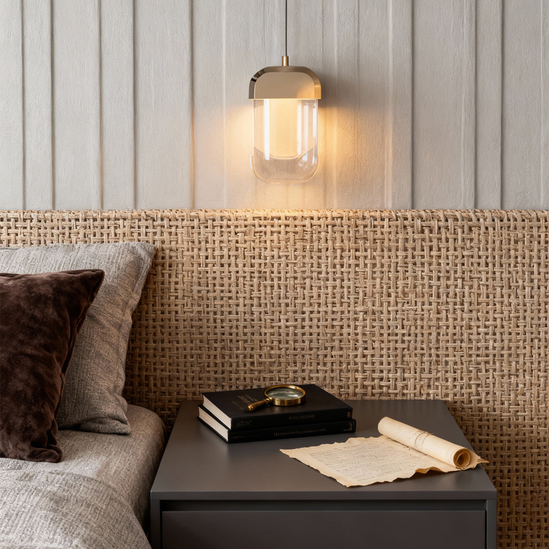 Modern crystal wall sconce lighting with multi-faceted glass diffuser creating warm bedside illumination.