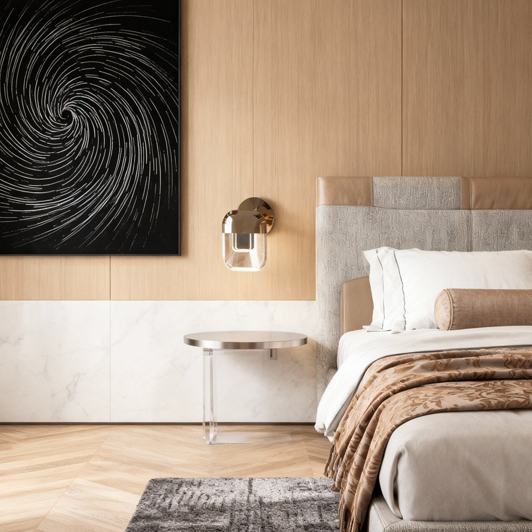 Crystal wall sconce lighting creating warm glow in modern bedroom with platform bed and textured accent wall