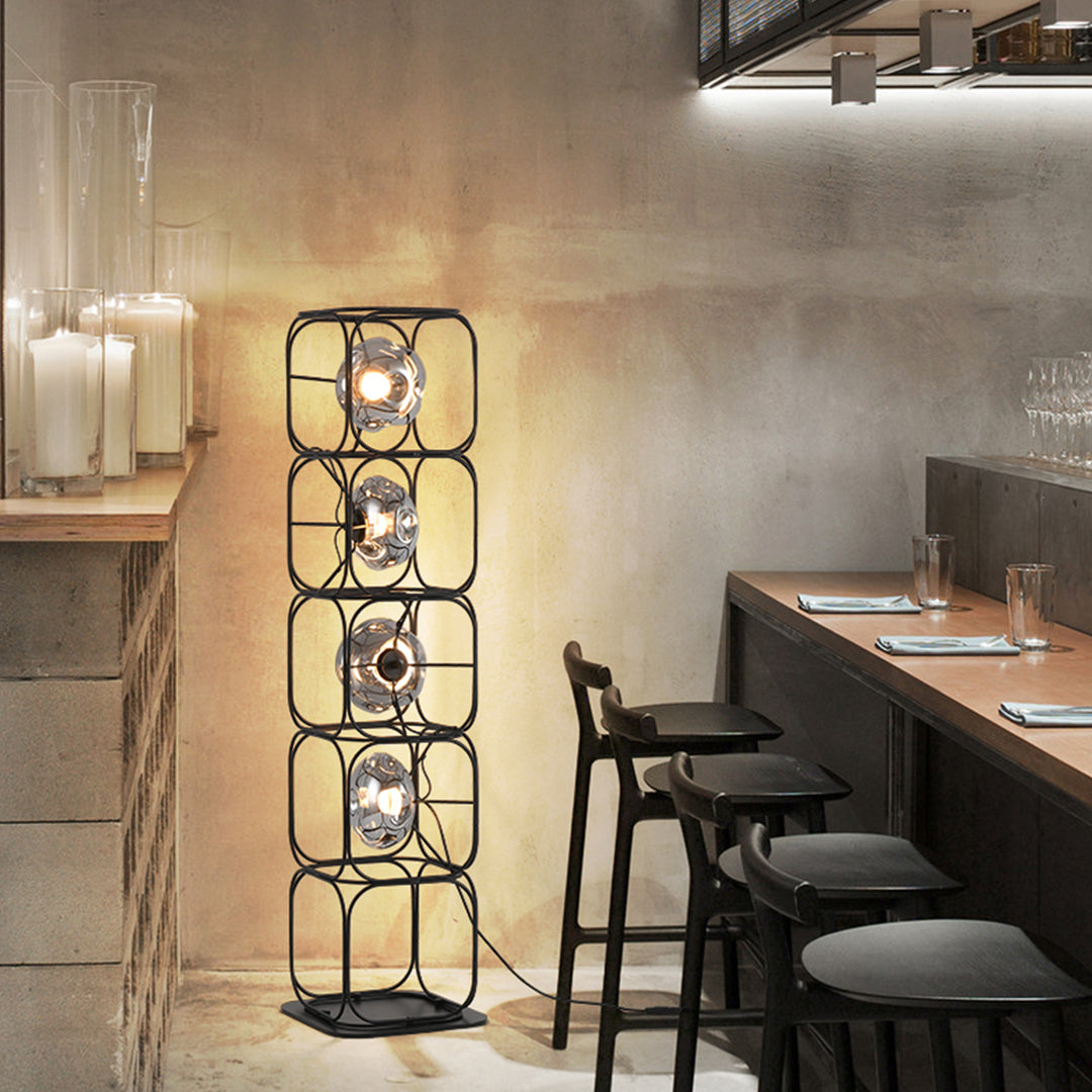 Cube table lamp illuminating modern dining space with warm ambient lighting and contemporary interior design