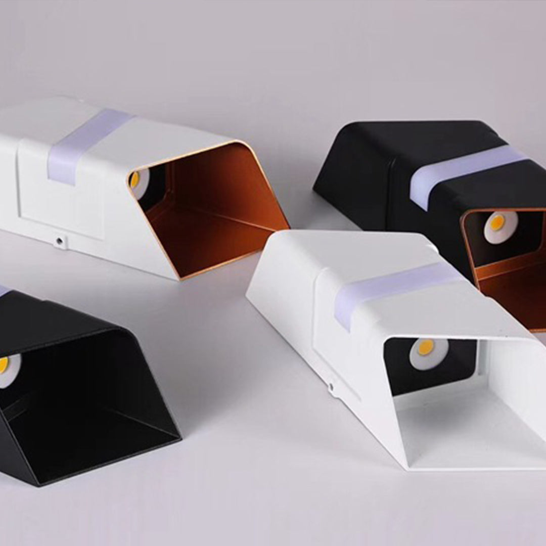 Collection of cubic wall sconces in various finishes displayed on neutral background