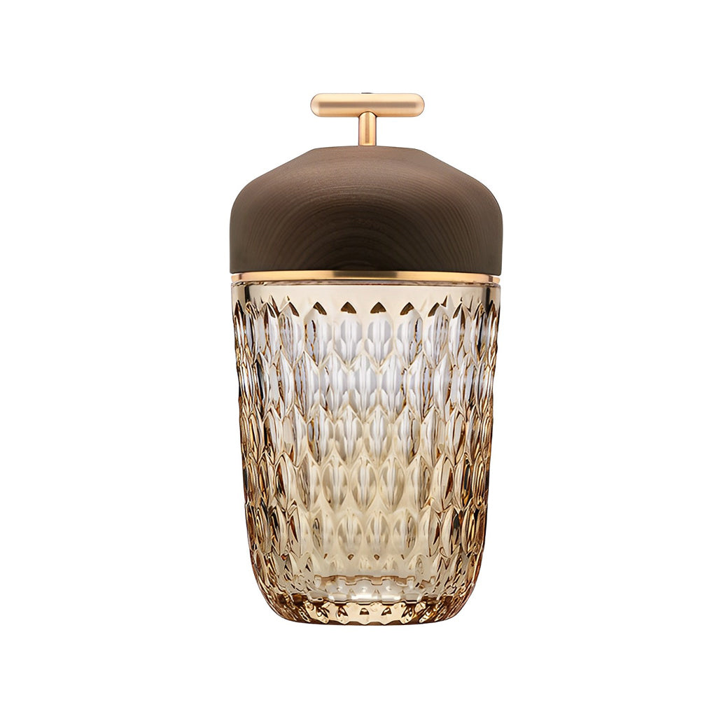 Detailed view of the gold handle and base of a cup glass table lamp.