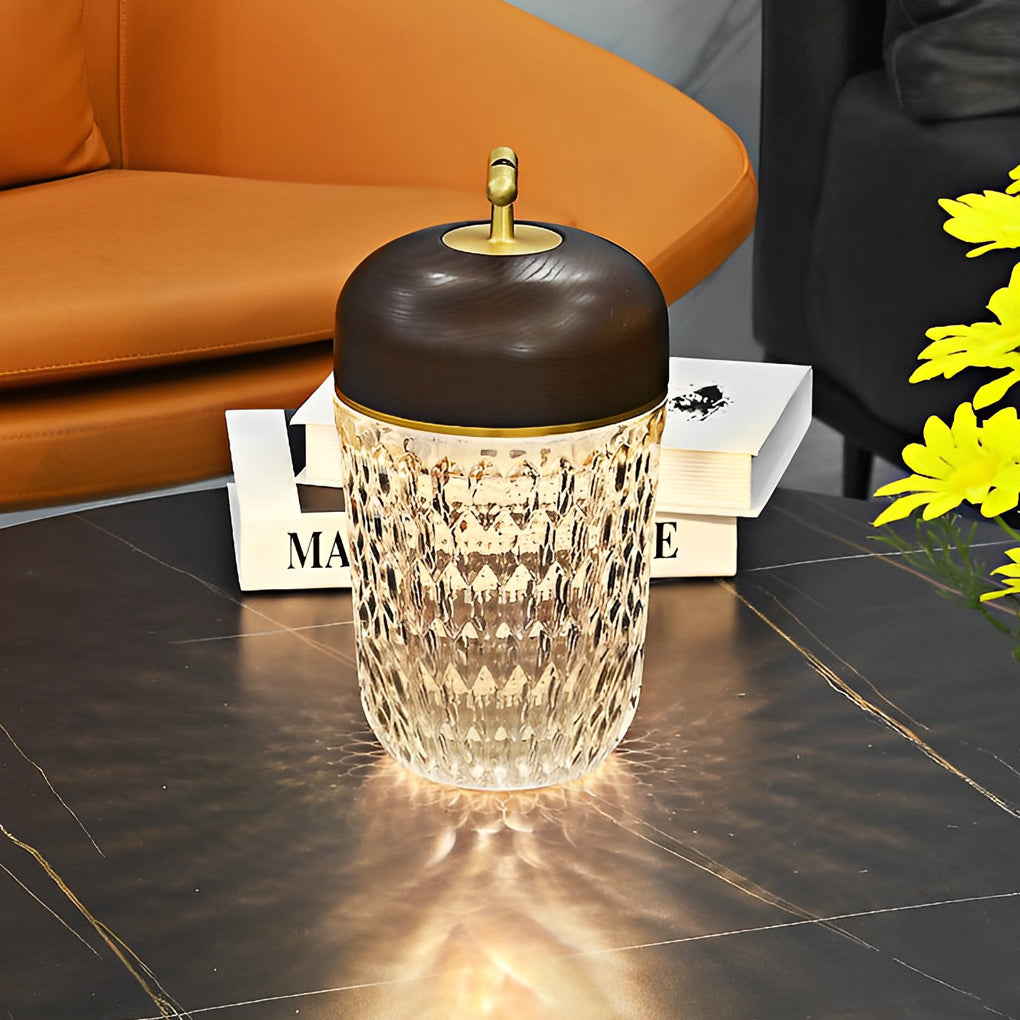 Chic cup glass table lamp with a wooden lid, illuminating a black table with yellow flowers.