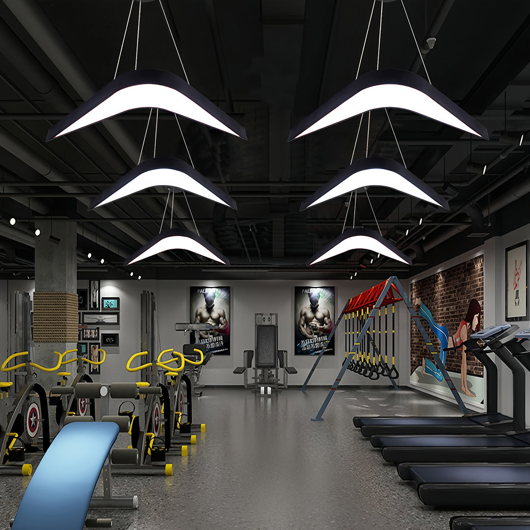 Wrought iron chandelier with unique curved arms, offering elegant and warm lighting for upscale interiors.