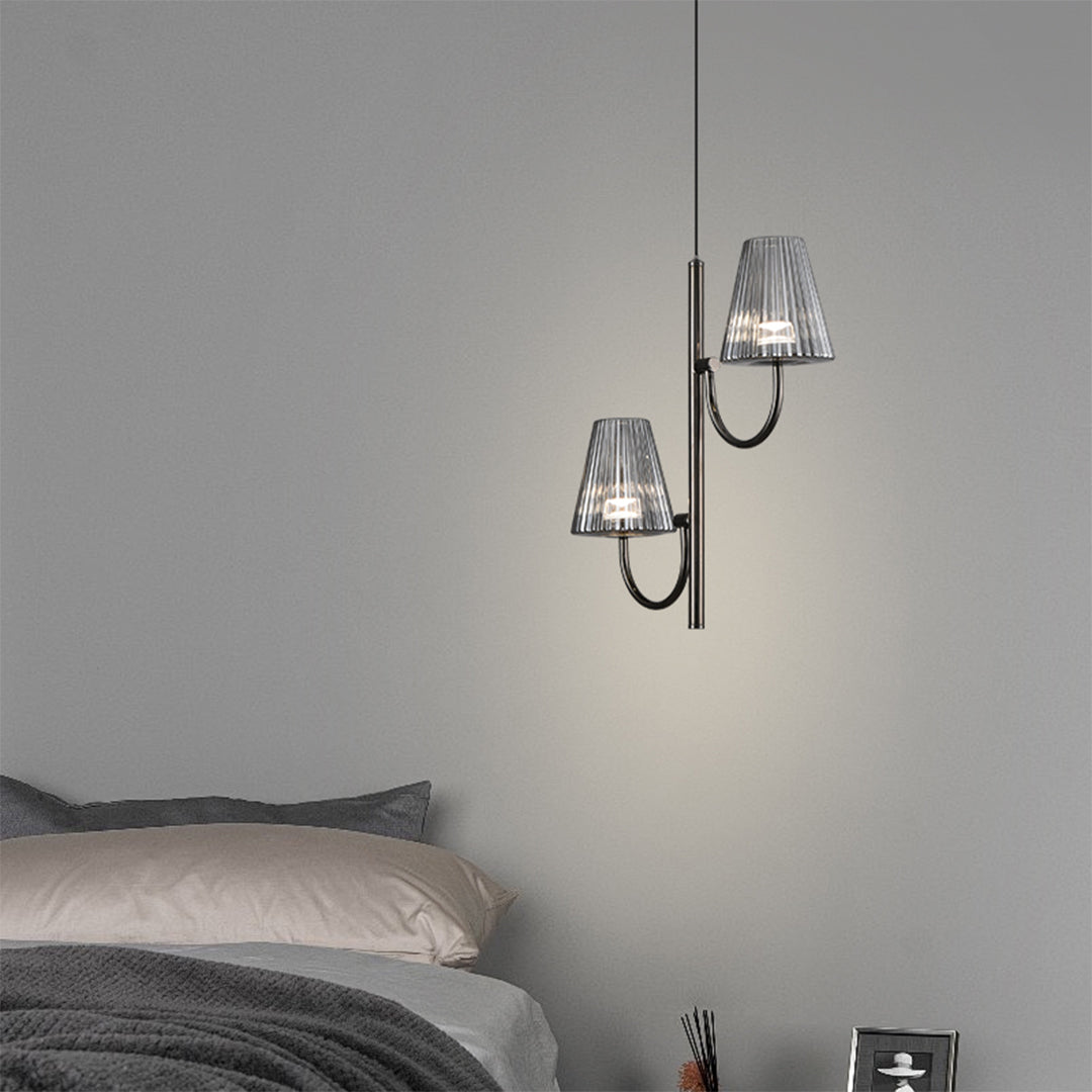 Curved black metal fixture arm with decorative rings connecting to textured glass shade