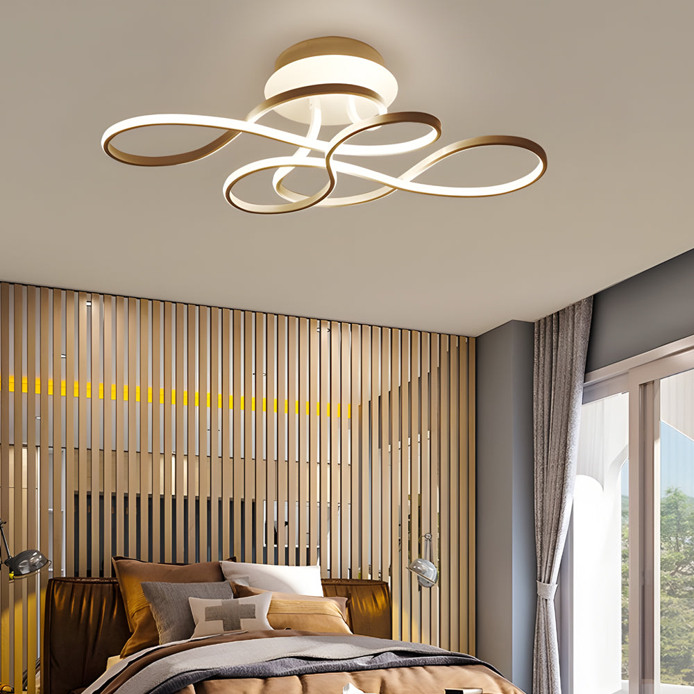Elegant curved ceiling light used in a modern bedroom with vertical wood slat accent wall.