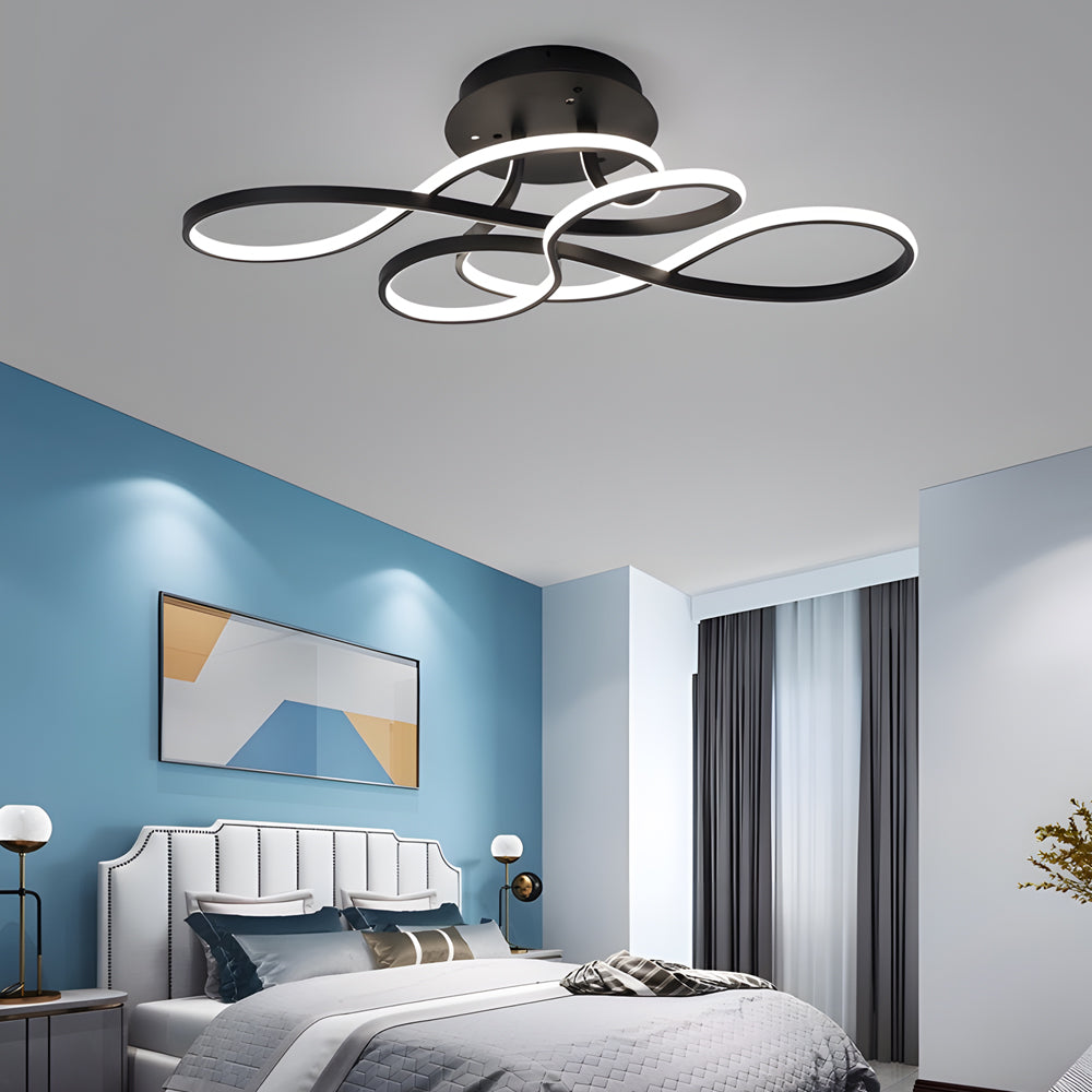 Black curved ceiling light isolated on a white background.