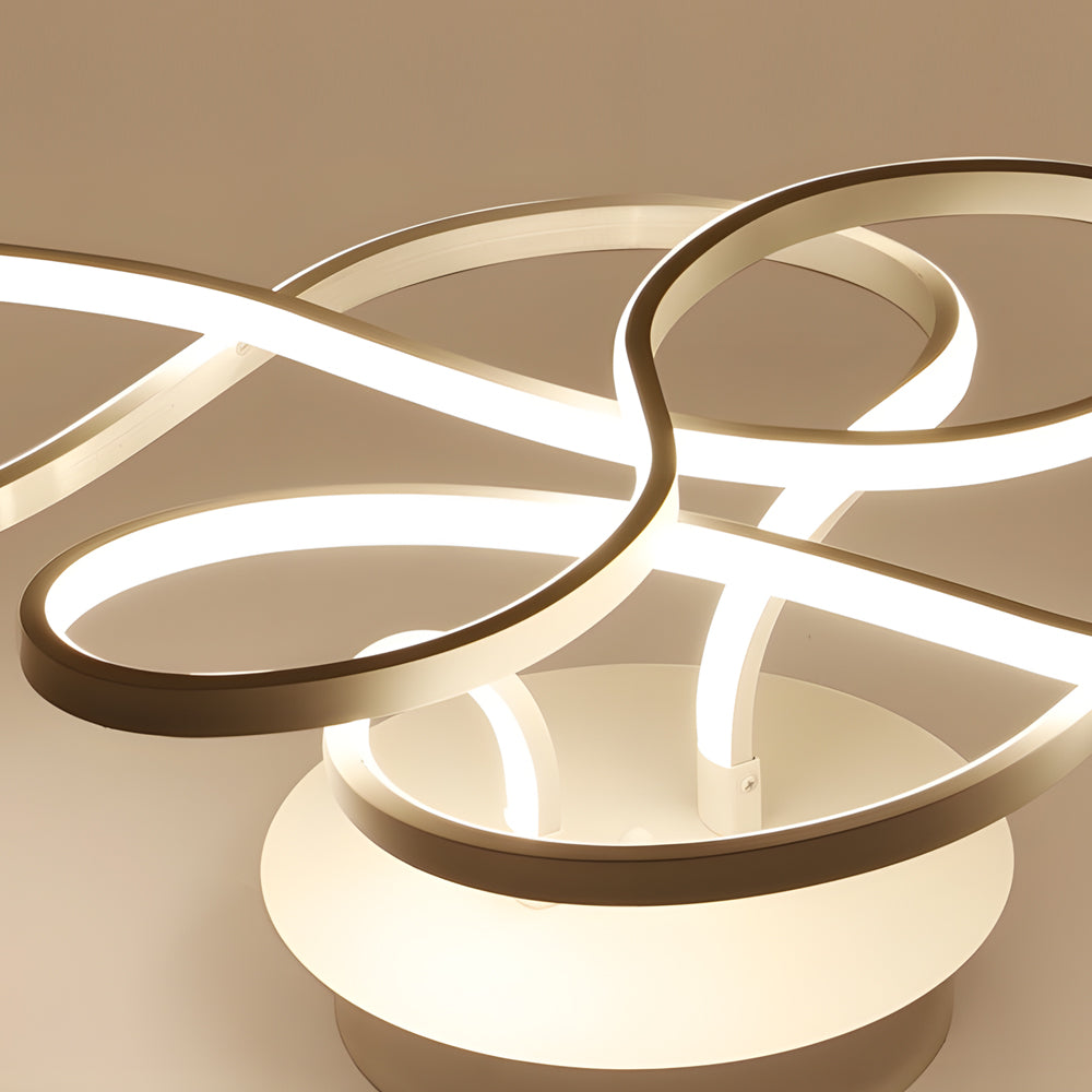Close-up detail of a curved ceiling light showing smooth LED light strips and metal finish.