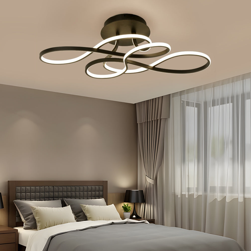 Curved ceiling light illuminating a contemporary bedroom with soft neutral tones.