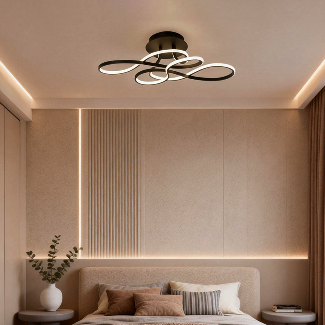 Modern curved ceiling light installed in a minimalist bedroom with warm ambient lighting.