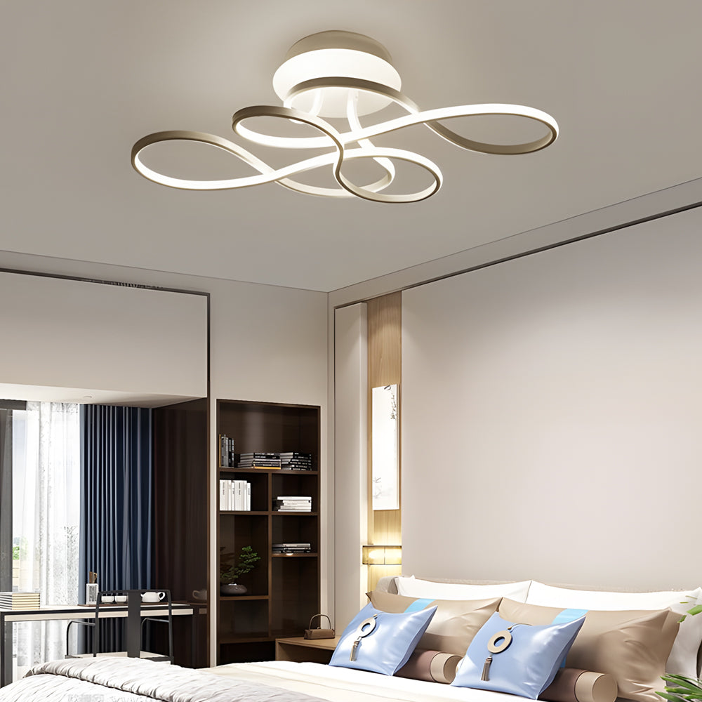 Curved LED ceiling light providing ambient lighting in a modern living space.