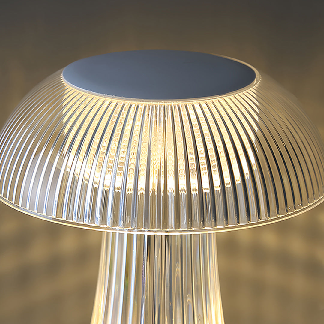 Clear table lamp with unique curved glass form creating beautiful light diffusion effects