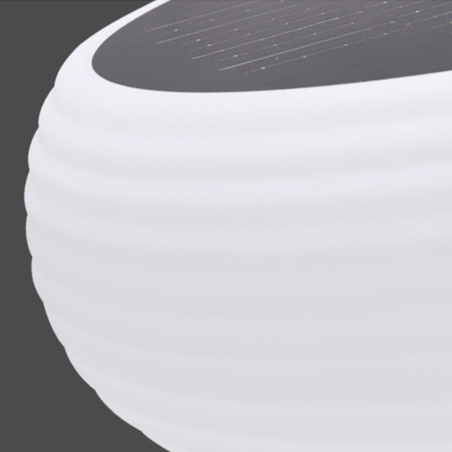 Close-up detail of contemporary white outdoor light with curved dome shade and sleek design