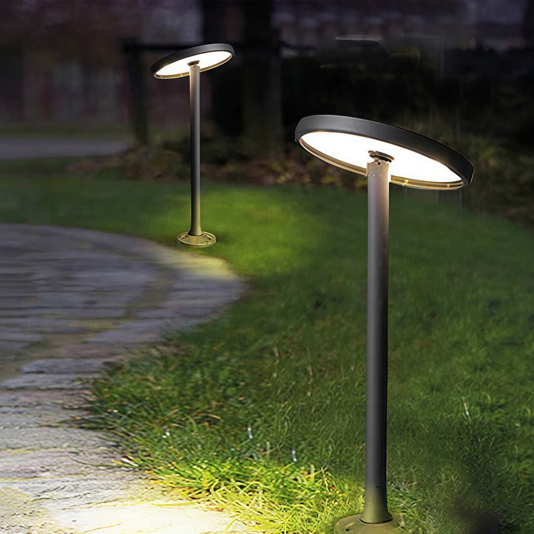 Low garden path lights outdoor installed beside curved stone pathway with soft landscape lighting.