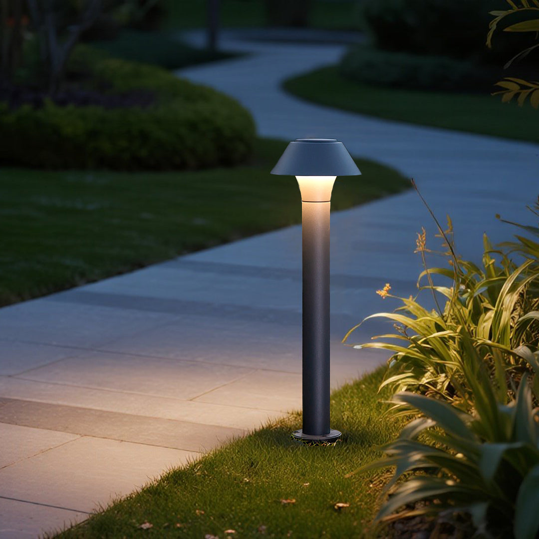 Modern pathway lighting fixtures positioned along curved garden walkway at twilight