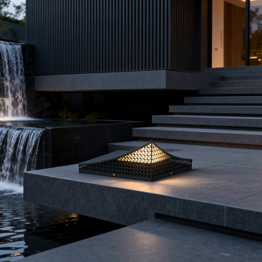 Curved landscape light casting a gentle glow on a stone pathway.