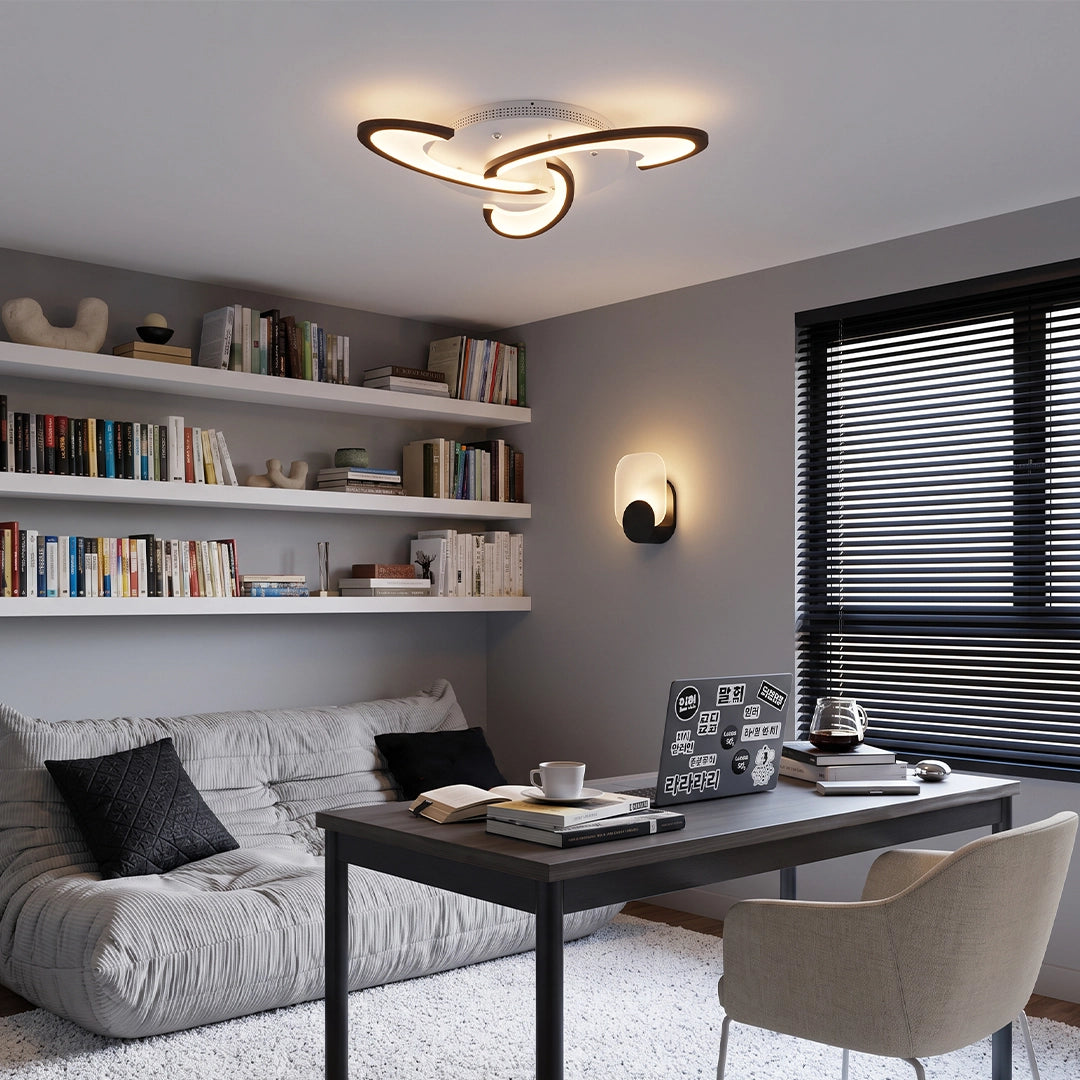 Curved LED ceiling light mounted in a home office, featuring a sleek looping design and warm ambient glow.
