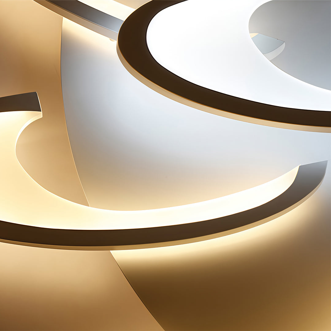 Close-up of curved LED ceiling light acrylic diffuser and metal frame.