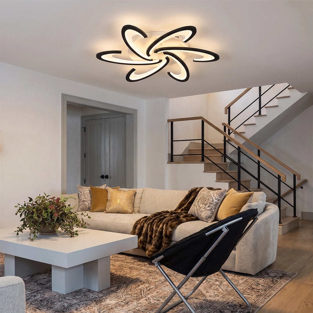 Curved LED ceiling light with a floral modern design illuminating a bright contemporary living room.