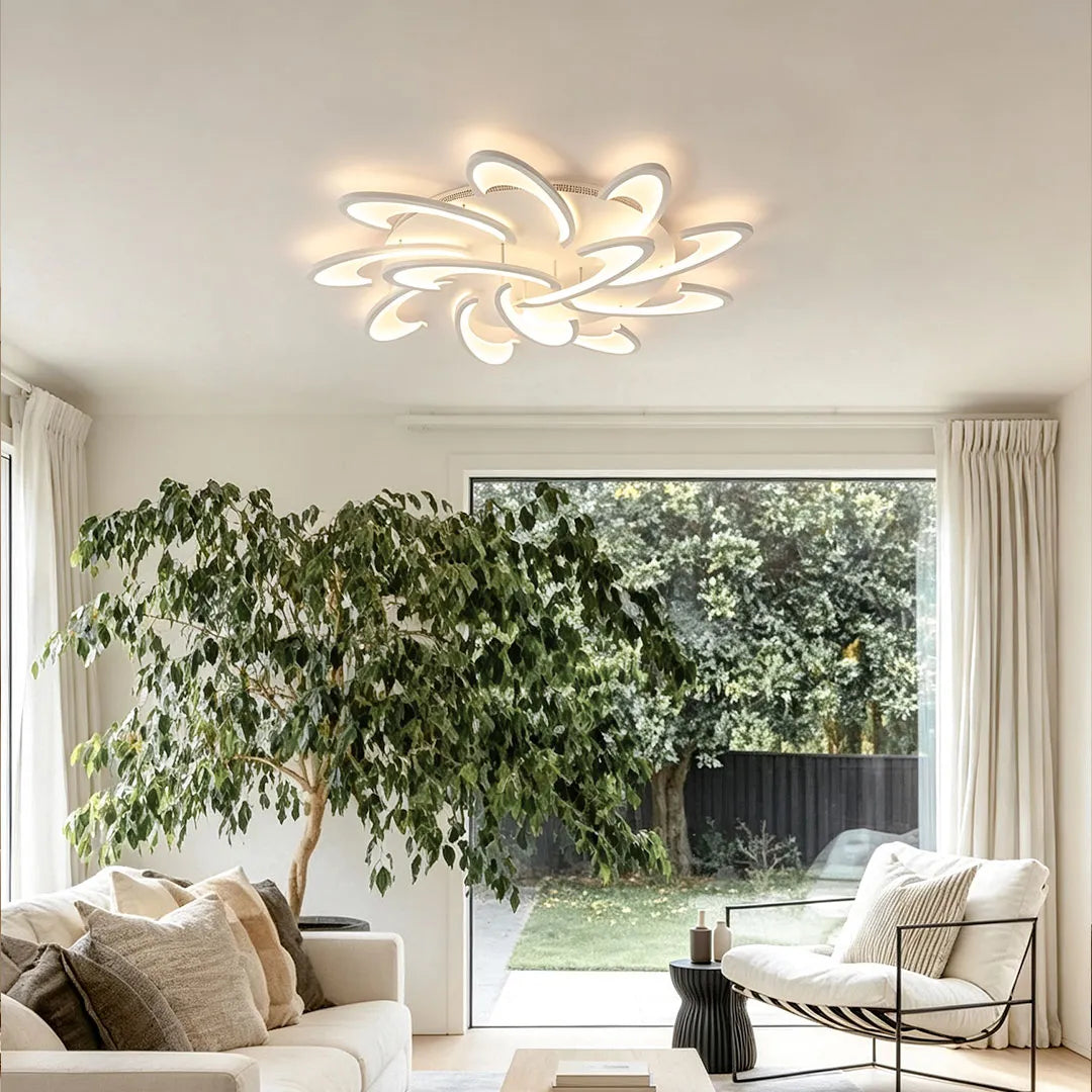 Curved LED ceiling light with a layered floral silhouette enhancing a spacious modern lounge with warm light.