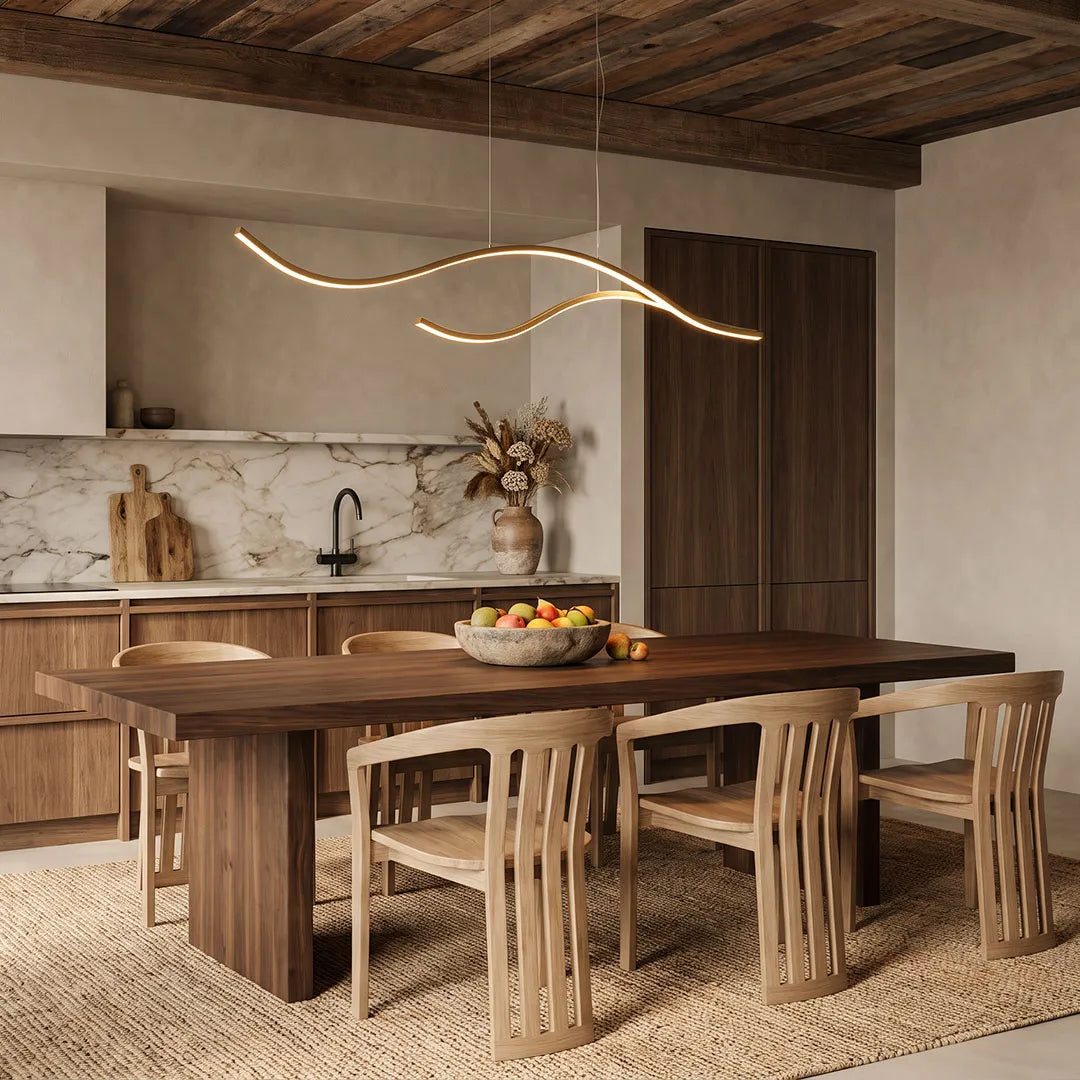 Curved LED pendant light hanging over a rustic wood dining table in a warm contemporary dining room.