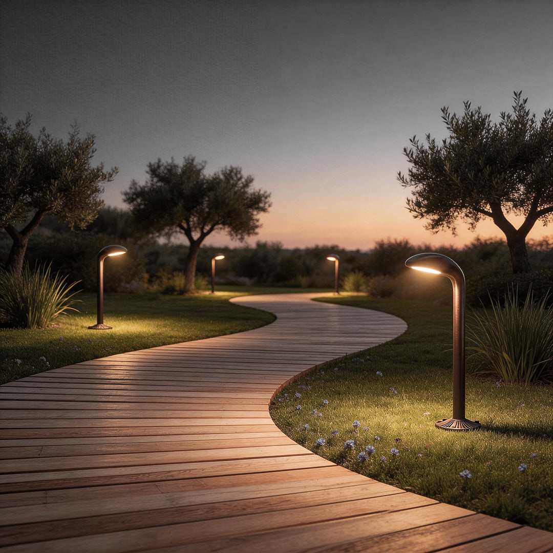 Curved path light illuminating a modern garden pathway with warm ambient glow at dusk.