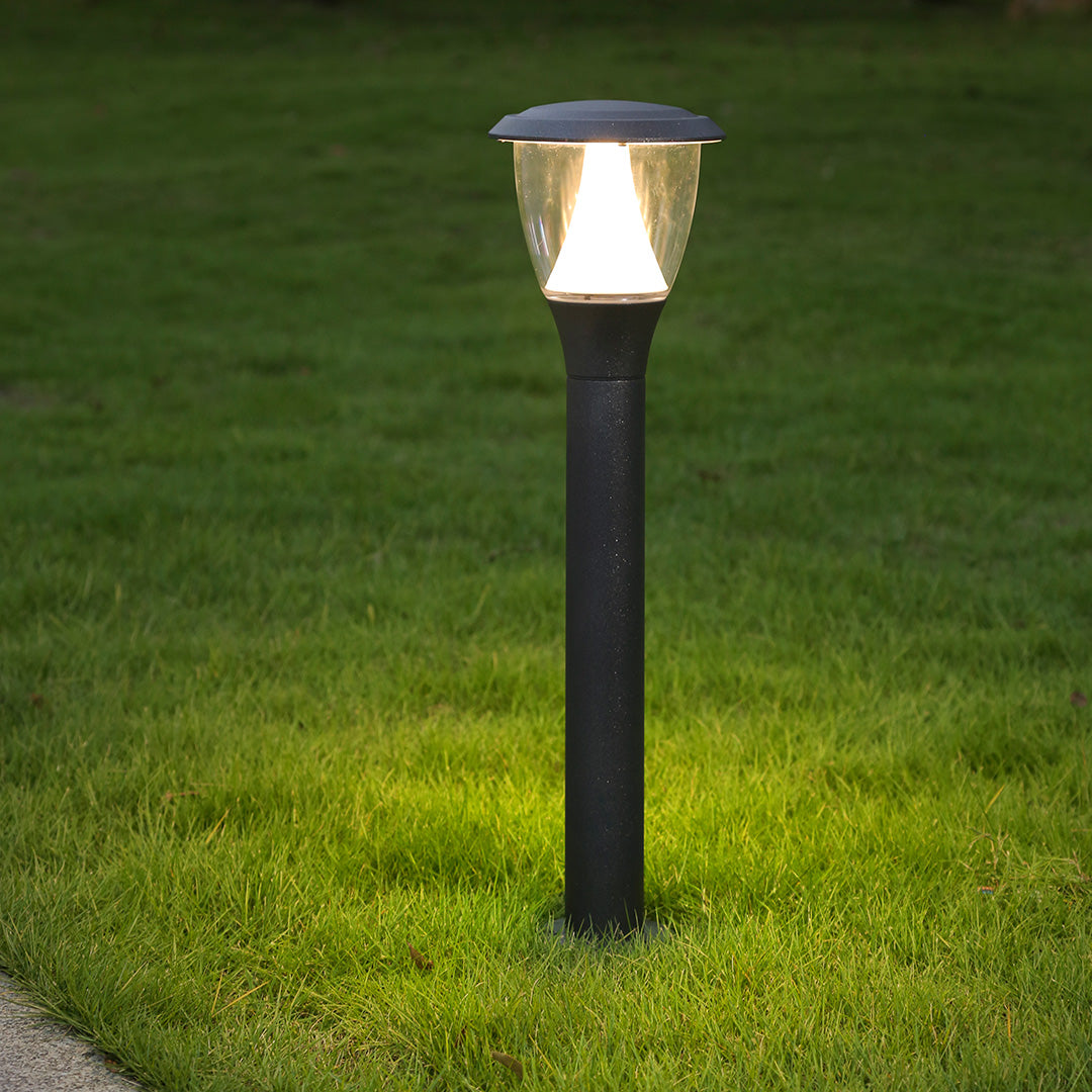 Acorn-style post light creating warm ambient lighting in residential garden area