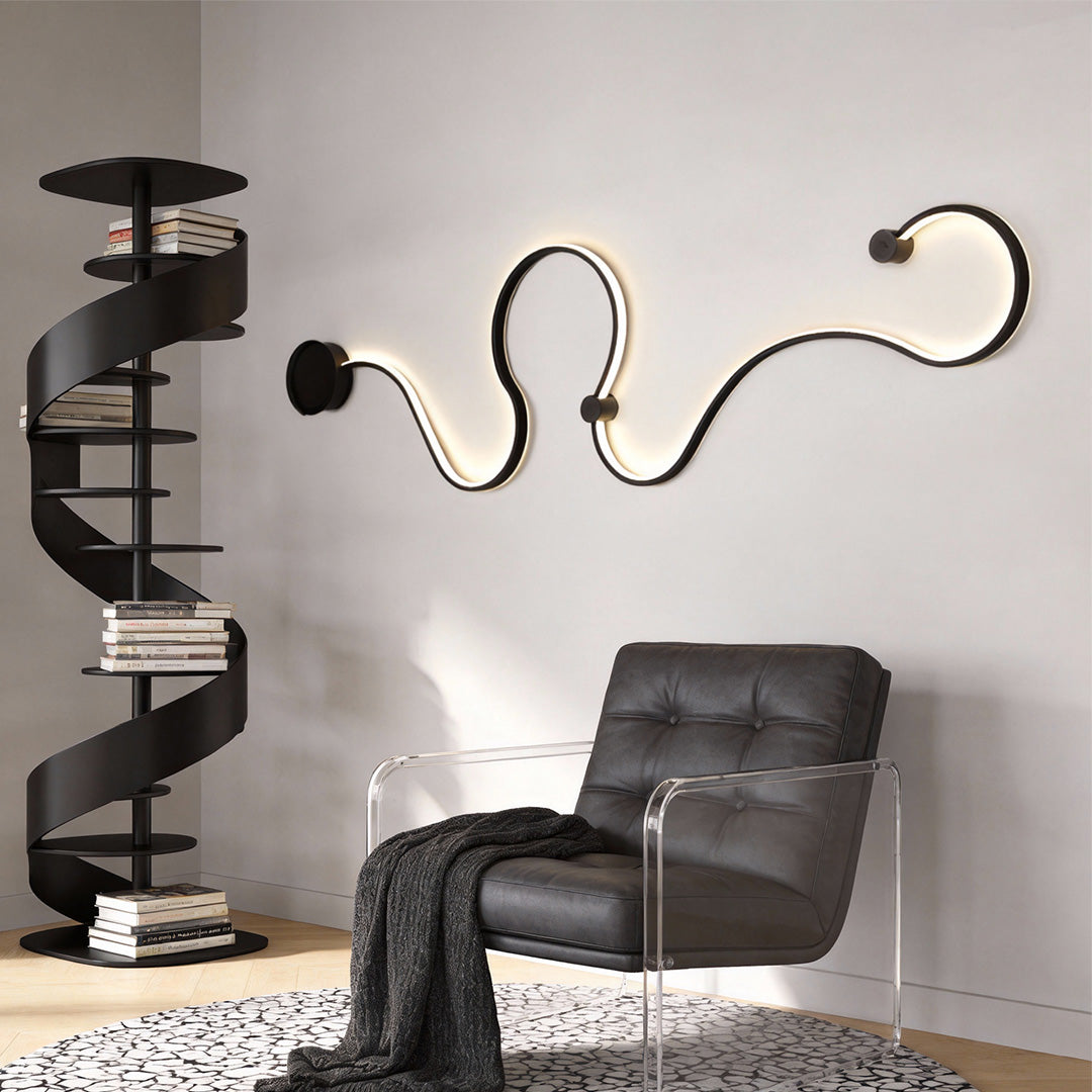 Minimalist curved wall sconce installed above lounge seating for indirect light.