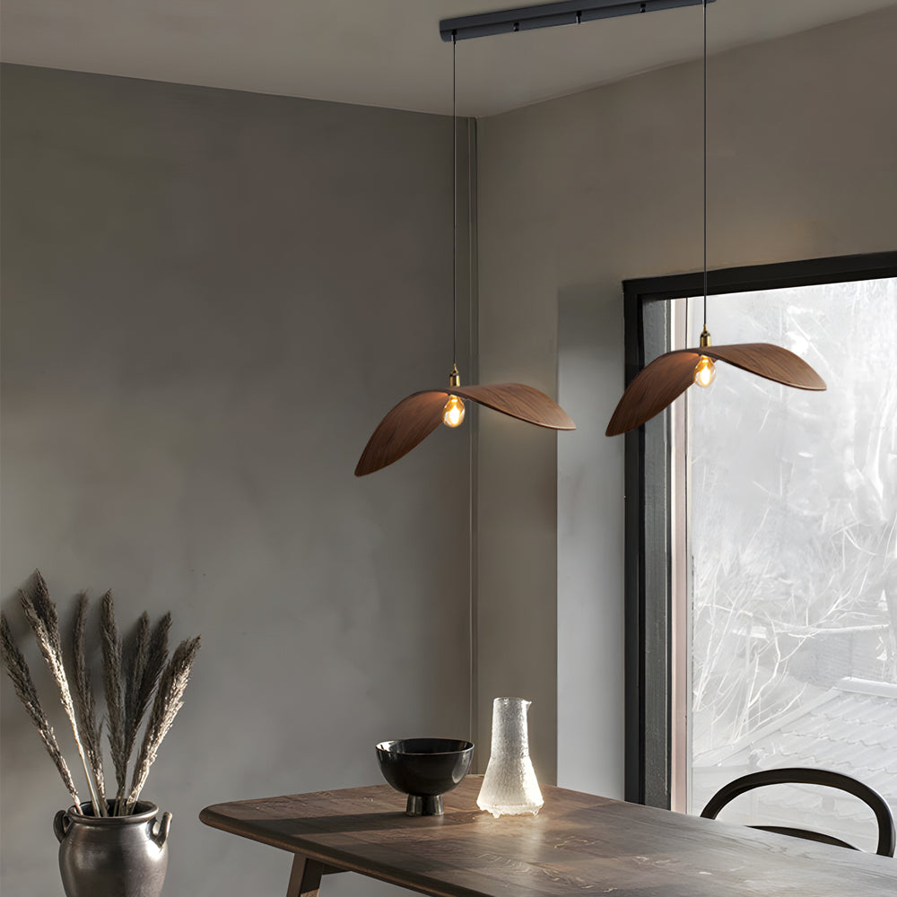 Curved wood pendant light providing warm illumination in a contemporary living space.