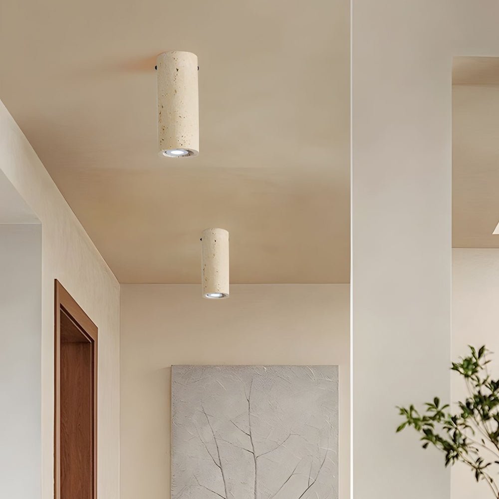 Cylinder downlight in a minimalist hallway, showcasing its sleek design and warm light against a neutral backdrop.
