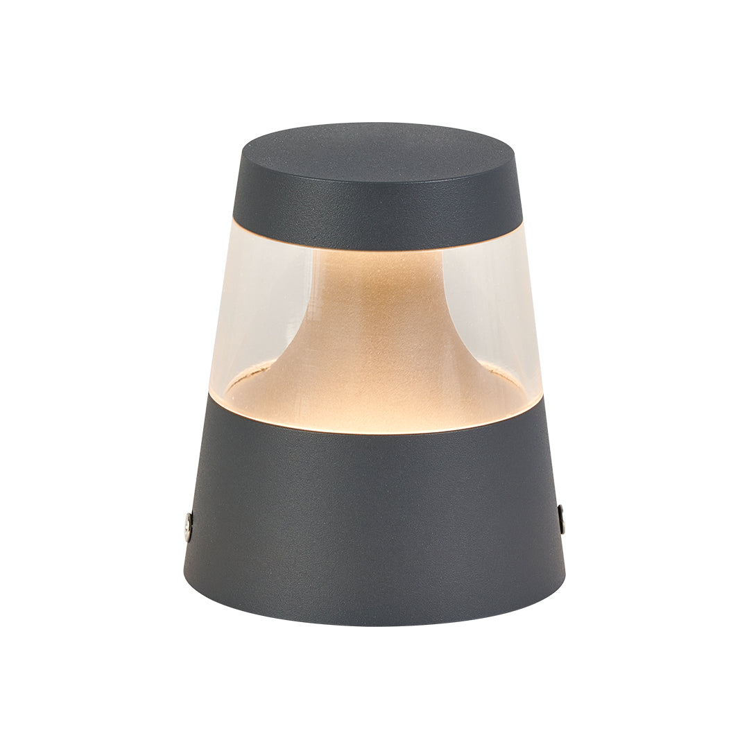 Modern black cylindrical LED path light with warm amber light band for subtle landscape illumination