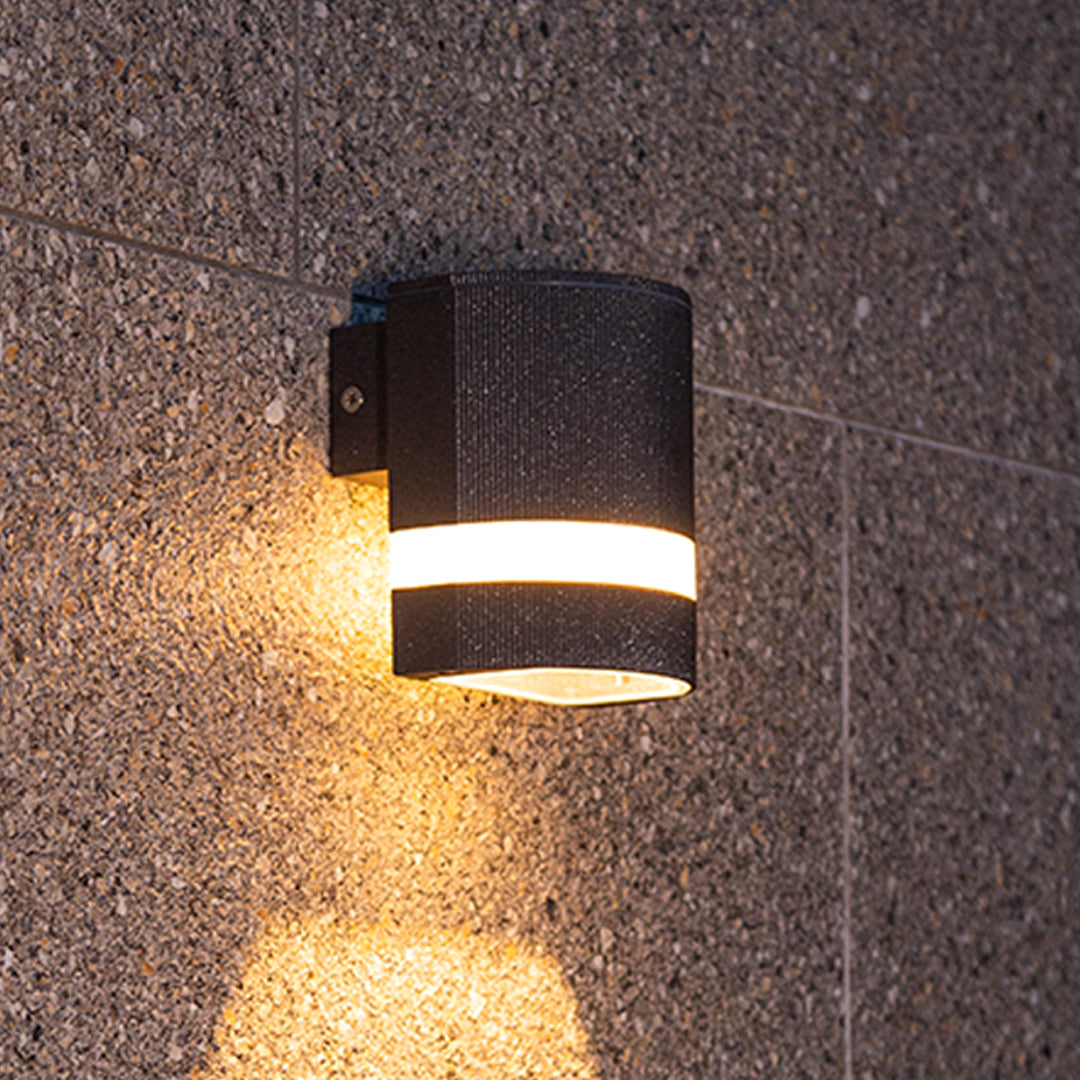 Cylindrical black garden wall light with dual white bands creating bidirectional illumination