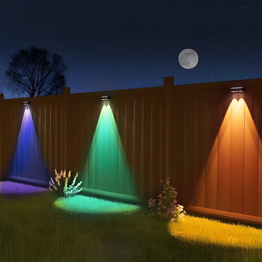 Wooden fence illuminated by colorful RGB LED lights creating vibrant blue, green and orange beams