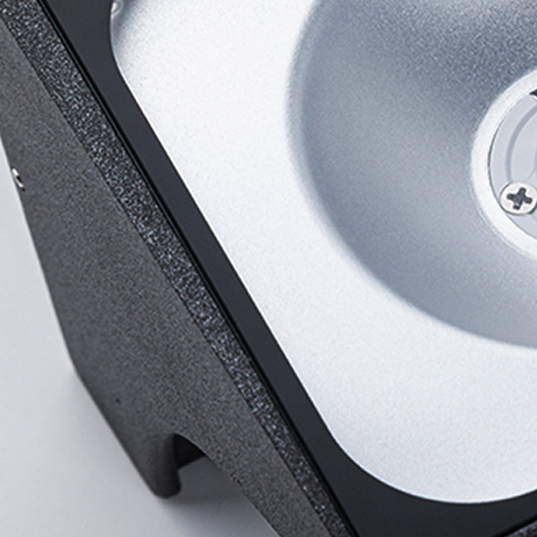 Traditional brass wall lantern with frosted glass shade mounted on stone exterior wall