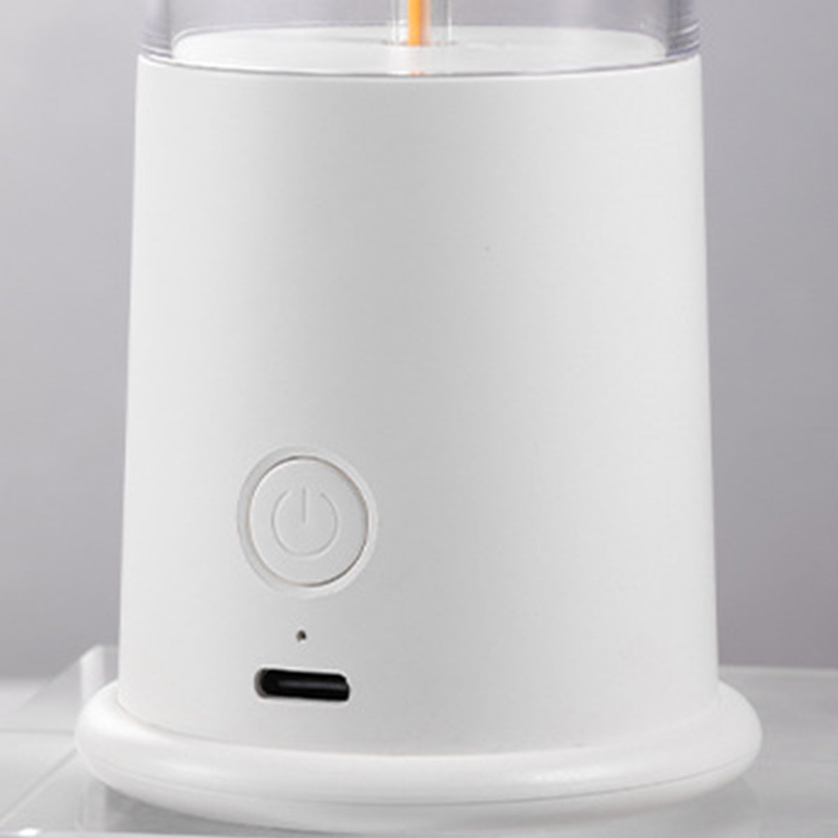 White cylindrical device with minimalist controls and sleek contemporary design aesthetic