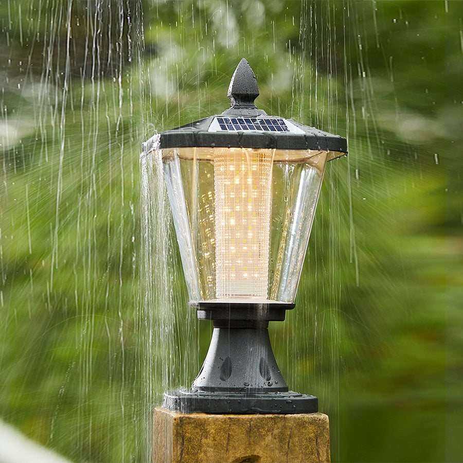 Weather-resistant post top light illuminated during rainfall showing durability and functionality