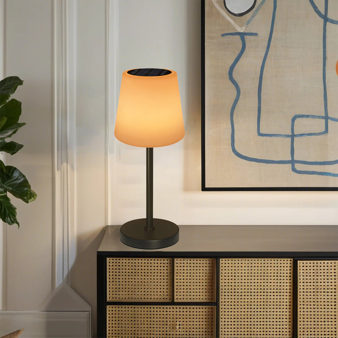 Rechargeable table lamp with warm glow positioned on wooden console in contemporary living room setting