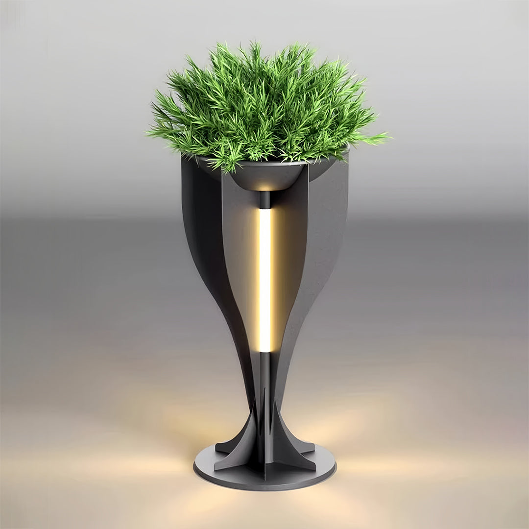 Dark grey modern lighted planter design with a central vertical light, shown filled with green plants.