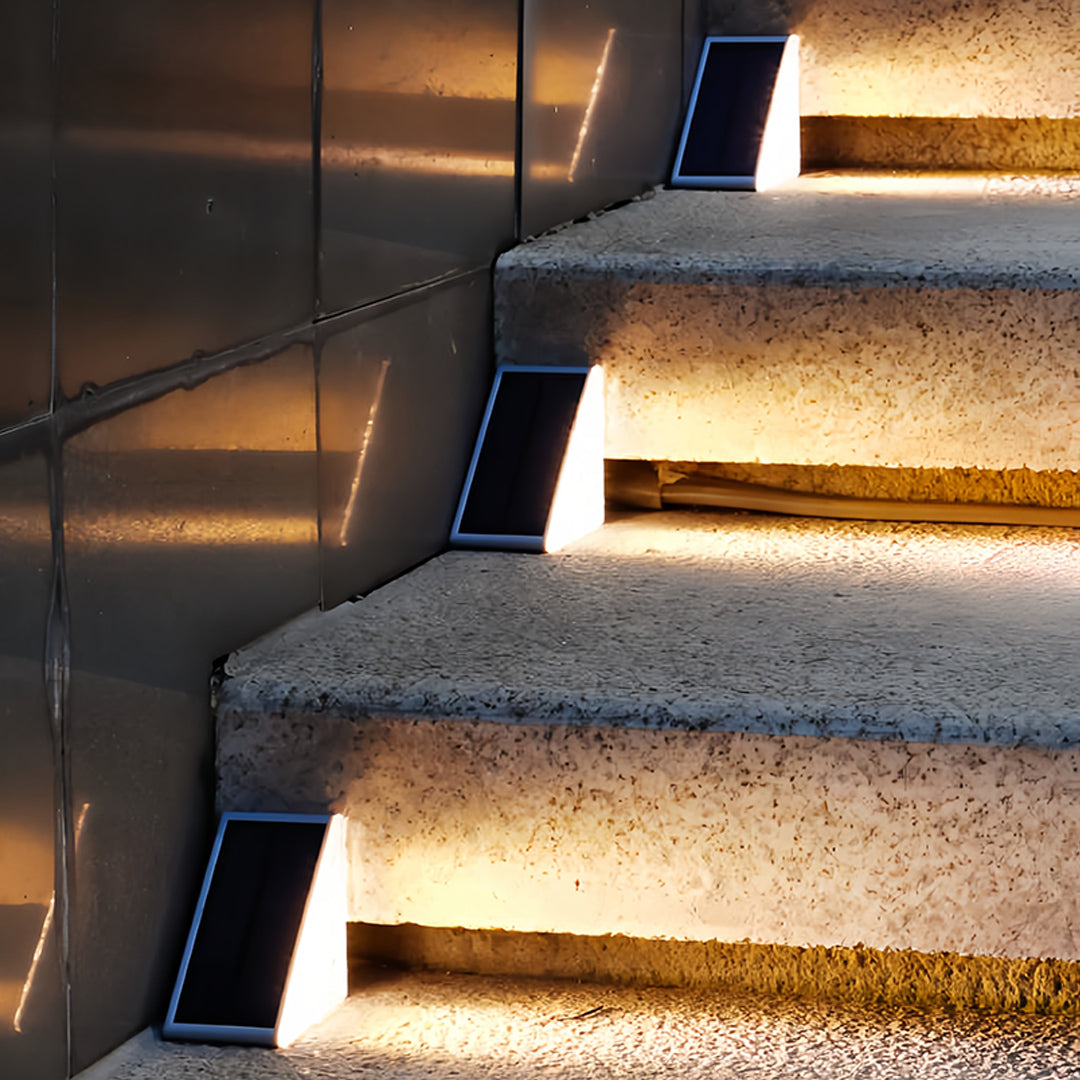 Contemporary outdoor solar step lights mounted on dark stairs providing energy-efficient safety lighting