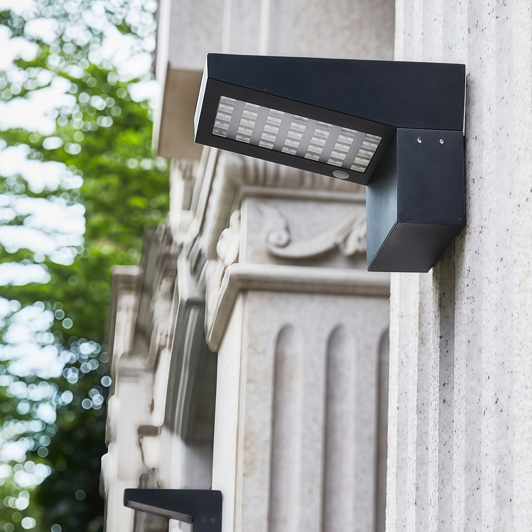 Daytime shot of modern wall mount outdoor light fixtures installed on decorative exterior columns.