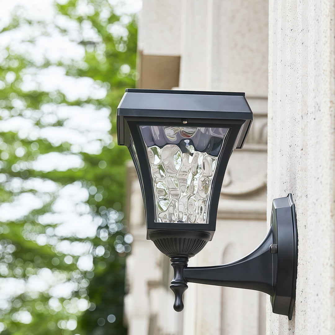 Daytime view of the black solar outdoor sconce lights showing the integrated solar panel on top.