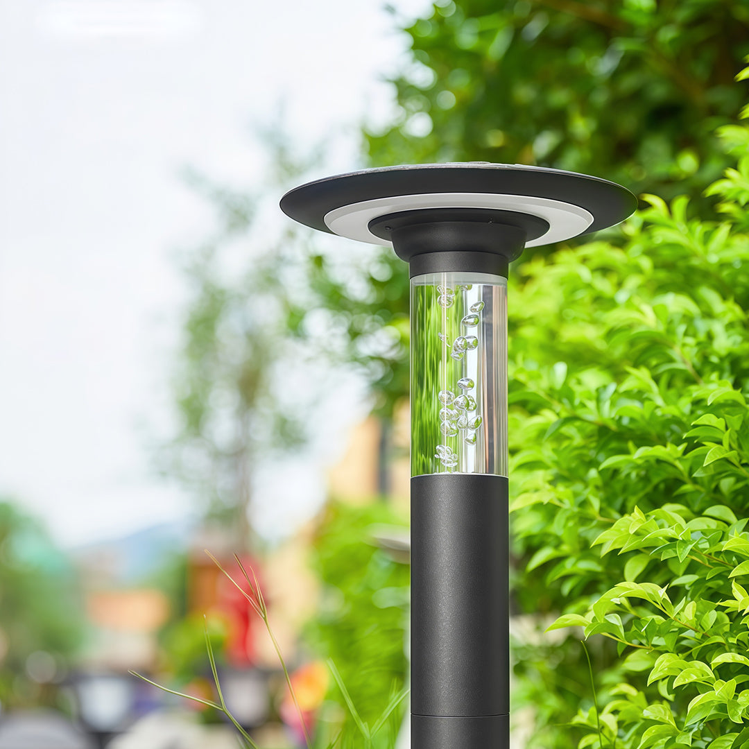 Daytime view of the outdoor path lights solar bollard showing the bubble glass cylinder and 'halo' solar panel.