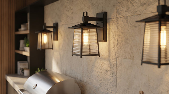 Modern lantern outdoor wall light illuminating a cozy patio seating area with warm ambient lighting.