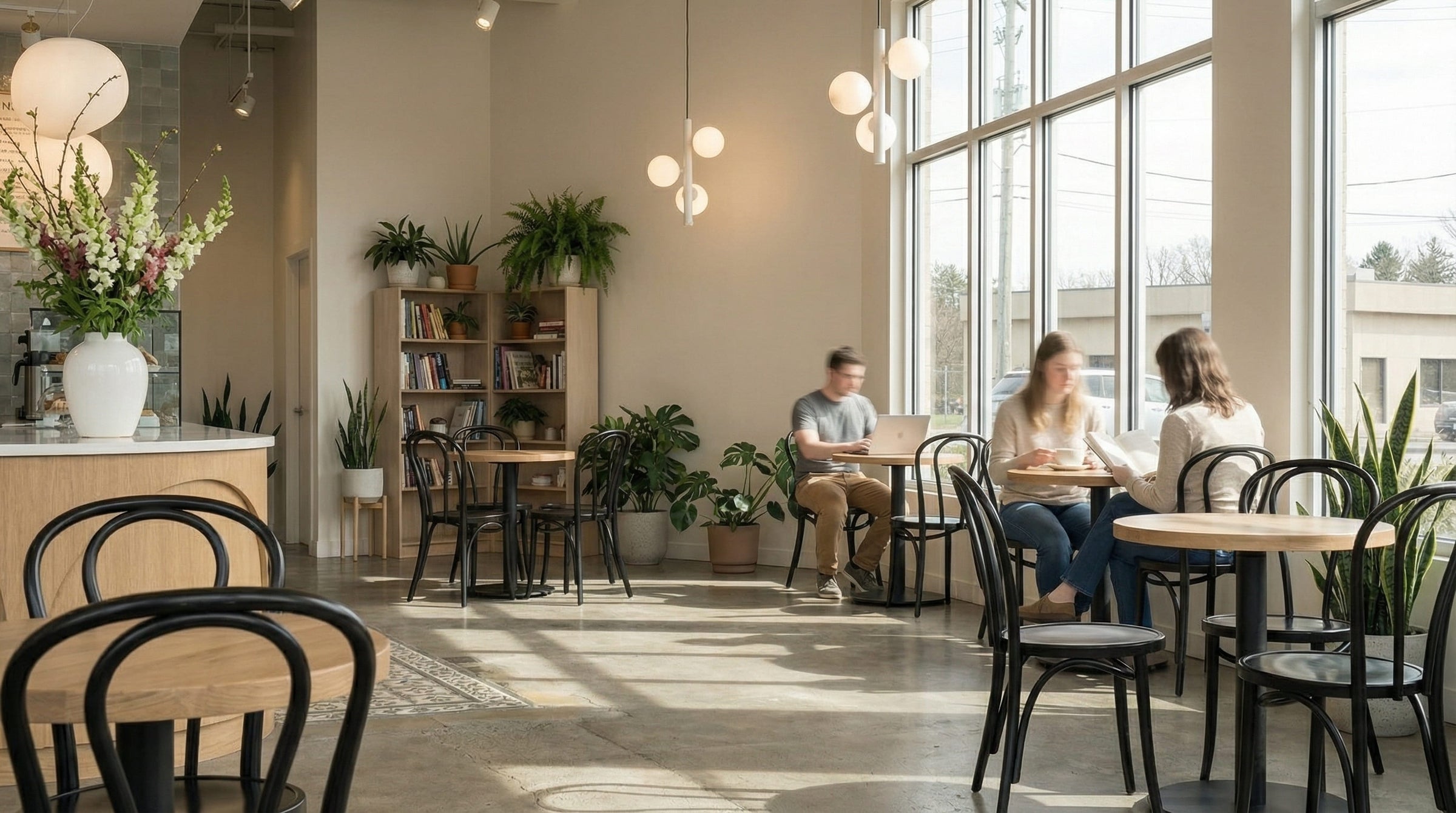 Cafe pendant detail showing warm illumination for a compact service and seating layout